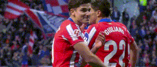 two soccer players are hugging each other on the field