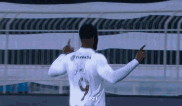 a man in a white shirt with the number 9 on the back