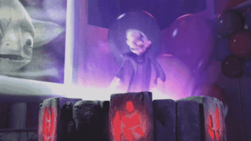 a purple light is shining on a statue of a man in a black shirt