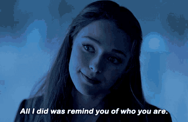 a woman in a dark room with the words all i did was remind you of who you are