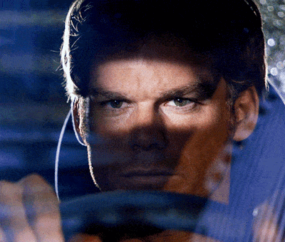 a close up of a man 's face behind a car window