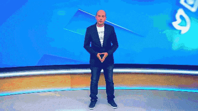 a man in a suit and a t-shirt that says ' i need a vacation ' on it
