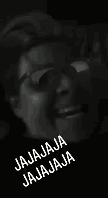 a black and white photo of a woman wearing glasses with the words jajaja jajaja on the bottom