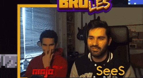 two men are sitting in front of a screen that says sees