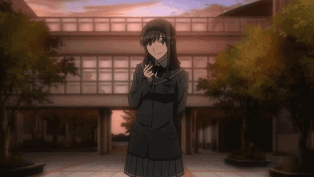 a girl in a school uniform stands in front of a building holding a cell phone