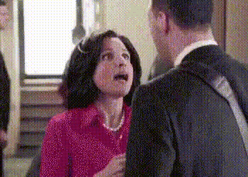 a man and a woman are talking to each other in a room .