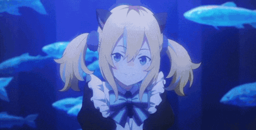a girl with pigtails is looking at fish in a tank .