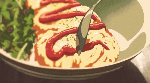 a plate of food with ketchup on it and a spoon
