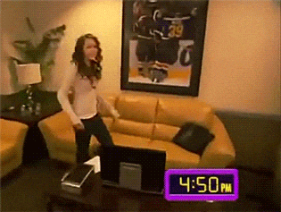 a woman is dancing in a living room with a clock reading 4:50 pm