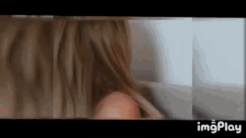 a close up of a woman 's hair being brushed by a man .