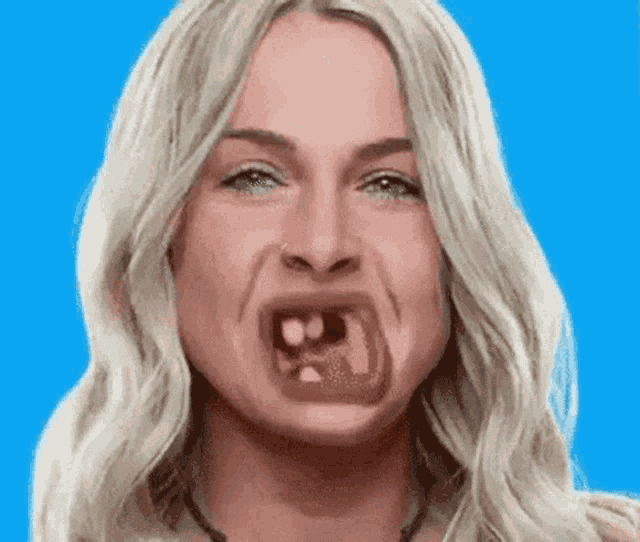 a woman is making a funny face with her mouth open