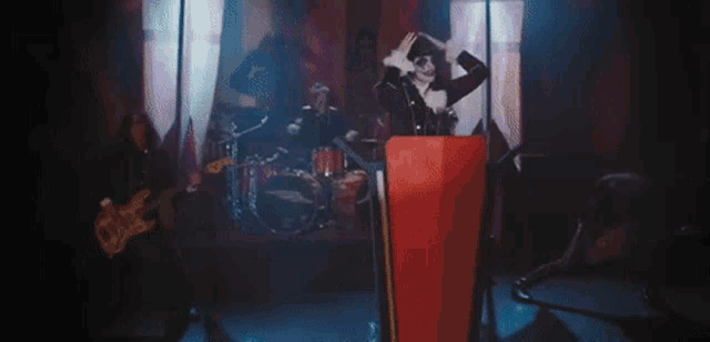 a woman is standing at a podium giving a speech while a band plays behind her .