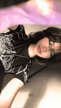 a girl is wearing a black shirt that says tik tok