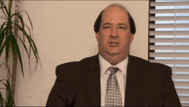 a man in a suit and tie looks at the camera