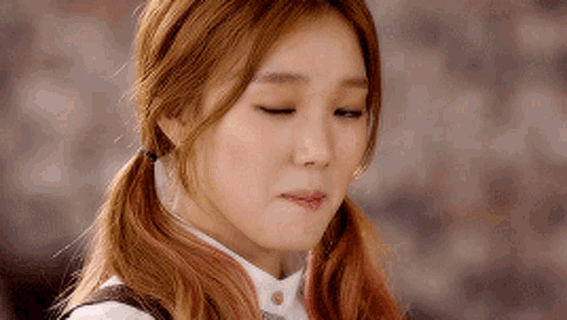 a close up of a woman making a funny face with her eyes closed