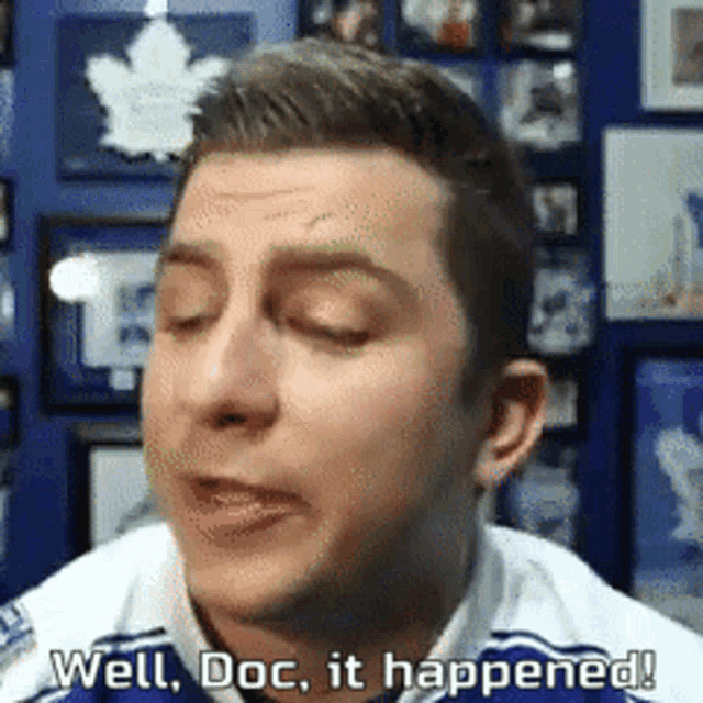 a man says well doc it happened in front of a wall of pictures