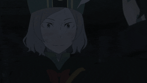 a girl in a green hat is looking at the camera in the dark