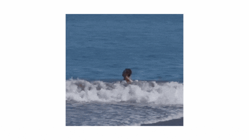 a man without a shirt is standing in the water