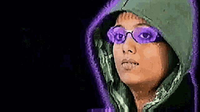 a woman wearing purple sunglasses and a green hood