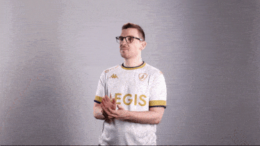 a man wearing glasses and a white shirt with legis on it