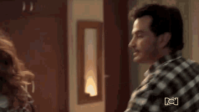 a man and a woman are standing next to each other and talking .