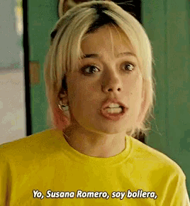 a woman in a yellow shirt is talking to another woman .