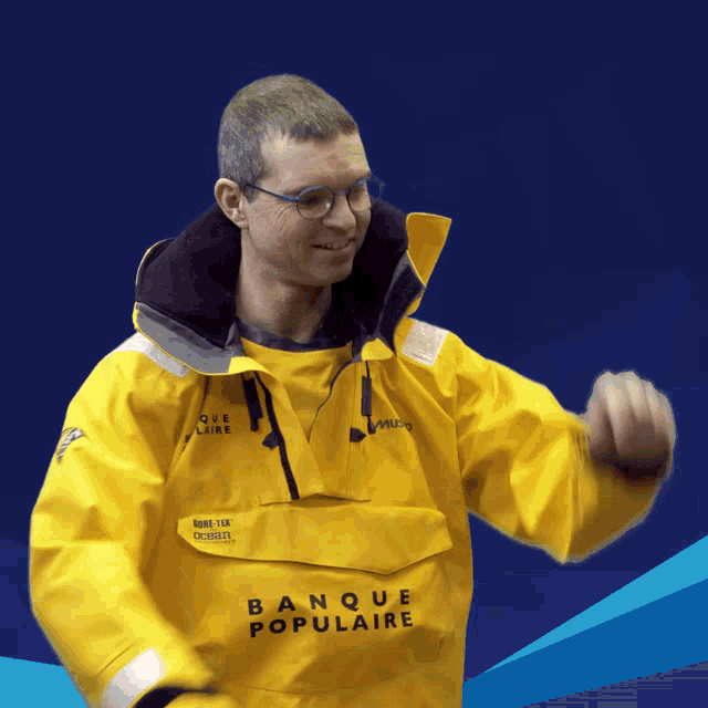 a man wearing a yellow jacket with banque populaire written on it