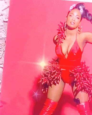 a woman in a red swimsuit with a flower in the background