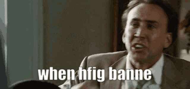 a man in a suit and tie is making a funny face and says when hfig banne .