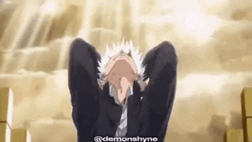 a man in a suit and tie is covering his face with his hands while looking up at the sky .