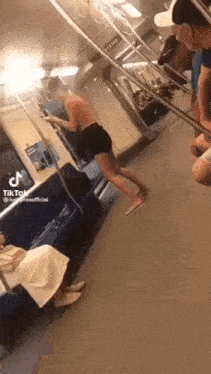 a woman without a shirt is walking on a train .