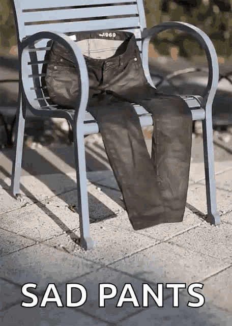 a pair of sad pants sits on a blue bench outside