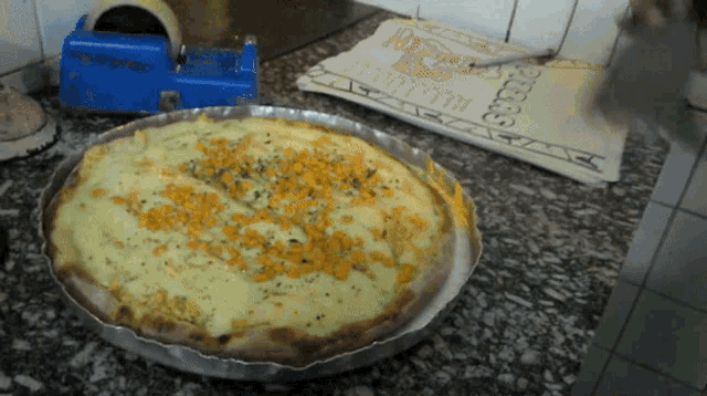 a pizza sitting on a counter next to a pizza bag that says pizza