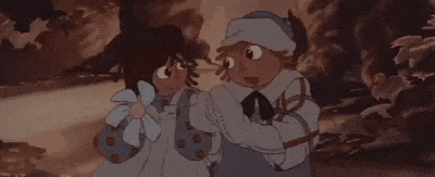 two cartoon characters are standing next to each other holding a baby .