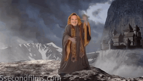 a man in a robe stands in front of a castle with the website 5secondfilms.com below him