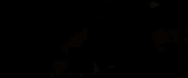 a man in a black suit has a red light on his back