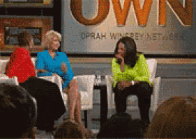 three women are sitting on a stage in front of a sign that says oprah winfrey network