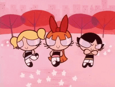 three girls from the powerpuff girls are jumping in the air .