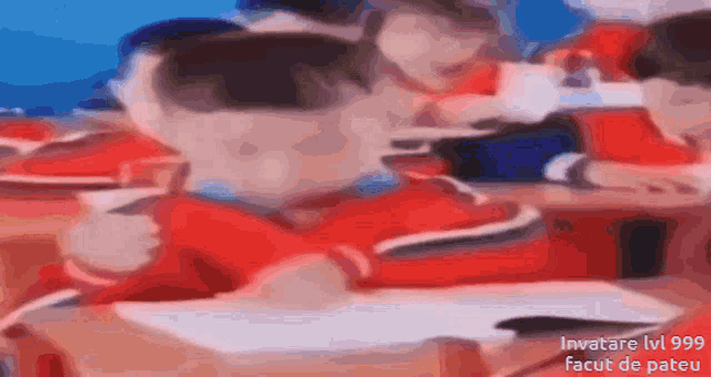 a blurry picture of people sitting at desks with the words invatare lv999 facut de pateu in the bottom right corner