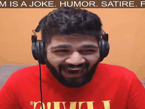 a man wearing headphones and a red shirt that says " m is a joke humor satire "