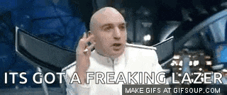 a bald man is talking on a cell phone and says `` it 's got a freaking lazer ''