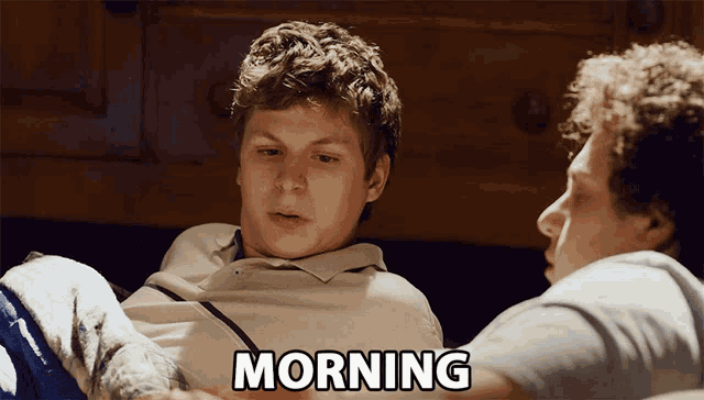 a man laying on a bed with the word morning written below him