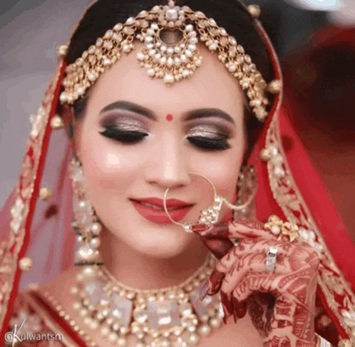 a bride wearing a nose ring and a red veil