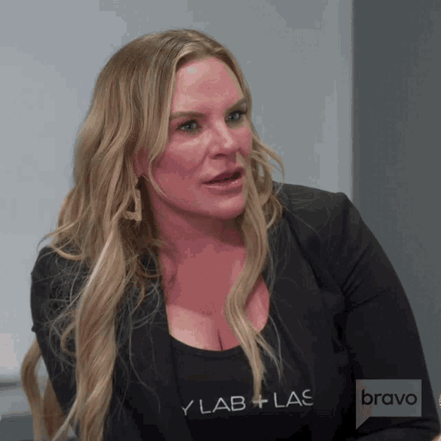 a woman is wearing a black shirt that says bravo on it