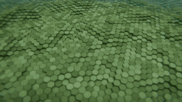 a bunch of green hexagons are lined up in a row
