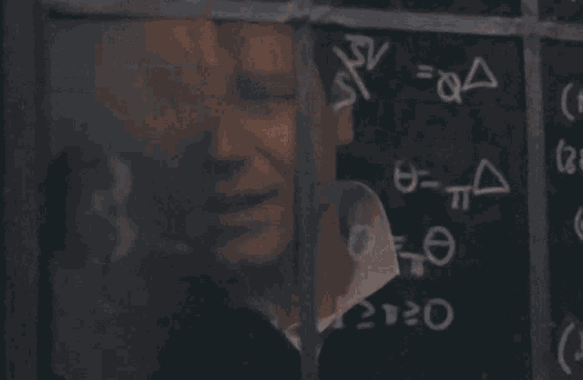 a man is looking through a window at a chalkboard with math equations on it