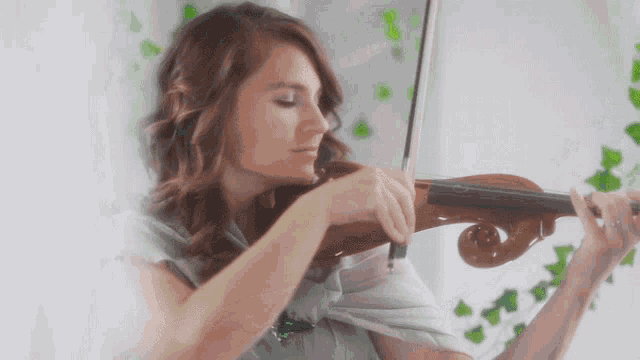 a woman playing a violin with a white background