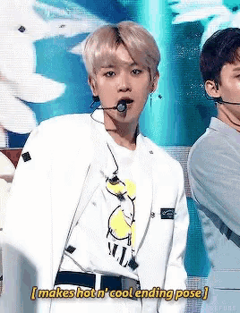 a man in a white jacket is standing in front of a microphone with the words makes hot n cool ending pose written above him