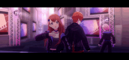 a boy and a girl are standing next to each other in a room with a lot of screens .