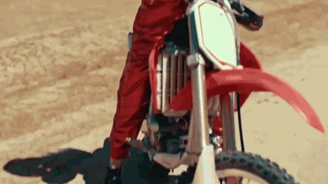 a person is riding a dirt bike on a dirt track .